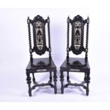 A pair of Flemish/Italian ebonised and bone inlaid side chairs with carved sea-scroll decoration