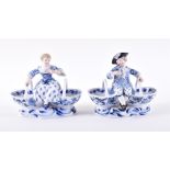 A pair of Meissen porcelain blue onion pattern figural salts modelled as a man and a woman sat