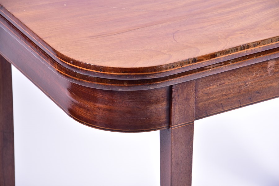 An Edwardian mahogany fold-over card table opening to reveal a green baize, on tapering legs, 90 - Image 3 of 3