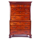 A fine George III mahogany chest on chest with stylised Greek key decoration and carved frieze