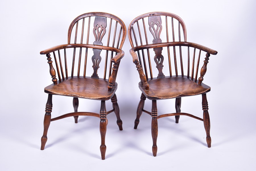 A near pair of 19th century elm and ash Windsor armchairs each with pierced vase splatbacks and