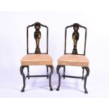 A pair of early 20th century Chinoiserie black lacquer bedroom chairs with gilt decoration, the