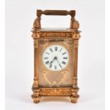 A late 19th century French gilt brass carriage clock with bevel edged glass panels, the enamel