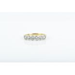 An 18ct yellow gold and diamond ring collet-set with six round-cut diamonds of approximately 0.60
