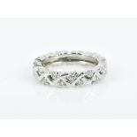 A platinum and diamond eternity ring the crossover style mount set all round with round brilliant-
