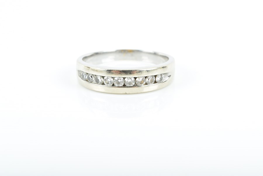 A diamond ring channel-set with nine round brilliant-cut diamonds weighing approximately 0.50 carats