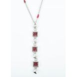 Zancan, Italy. An 18ct white gold, diamond, and ruby drop pendant necklace set with four square