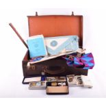 A vintage leather case filled with masonic garb and a writers compendium with faceted inkwells (