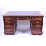 A large Edwardian mahogany partners desk  bearing a stamp for Maple & Co, with nine drawers opposing