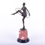 After Dominic Alonzo: a cast bronze figure of a semi-clad female hoop dancer the base with cast