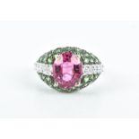 An 18ct white gold, diamond, pink tourmaline, and green garnet cocktail ring centred with a mixed