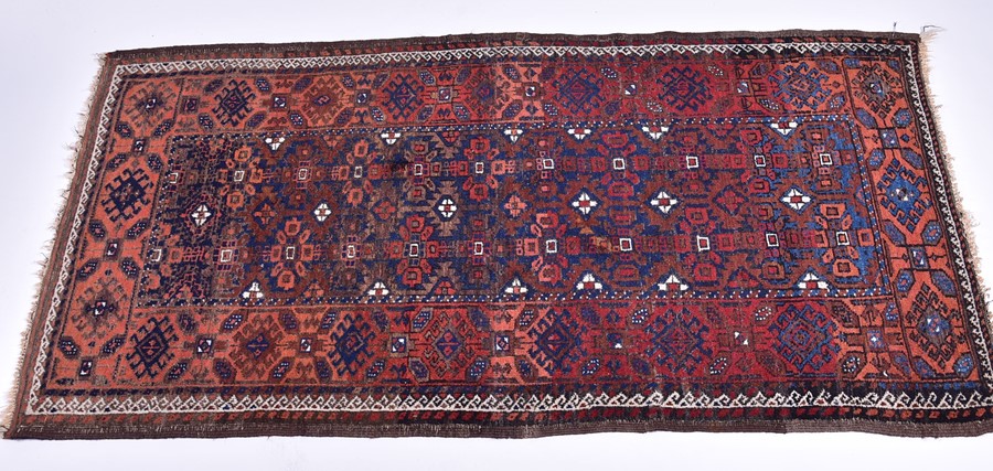 A late 19th/early 20th century Caucasian rug probably Daghestan in style, designed with madder red
