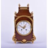A French ormolu mounted mantel clock in a fruitwood case eight day movement sticking on a coil gong,