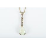 A diamond and opal drop pendant suspended on a yellow metal chain. 3.9 grams.
