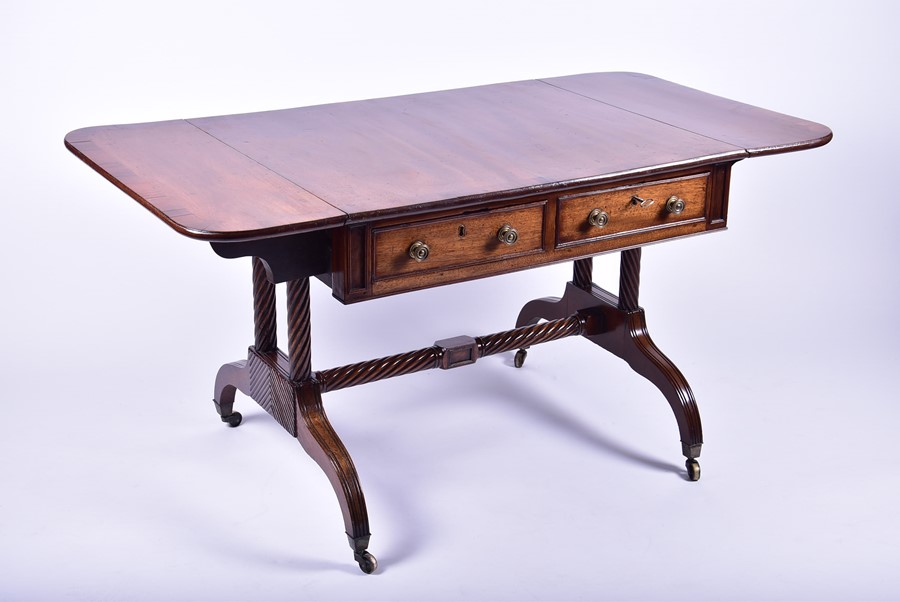 A Regency mahogany sofa table with two drawers (false fronts to one side), carved rope-twist