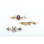 A late 19th / early 20th century yellow metal, amethyst, and seed pearl bar brooch together with a