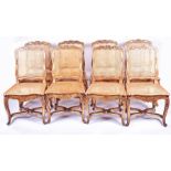 A set of eight gilt-painted French style dining chairs  with cane seats and backs and carved