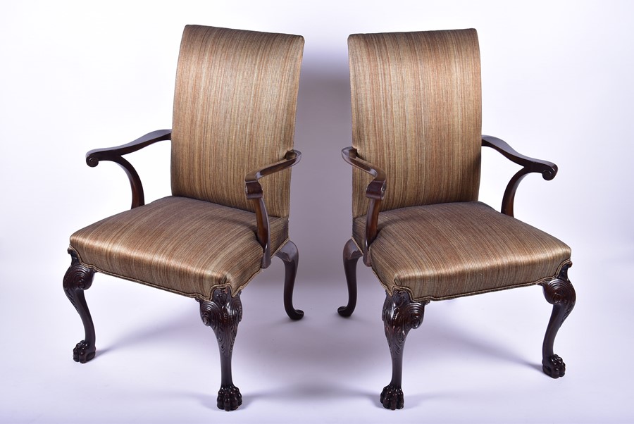 A pair of George II style antique 'Gainsborough' armchairs possibly reproduction, each with