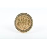 A 9ct yellow gold sovereign ring mounted with a full sovereign dated 1911, within gold ring with