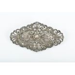 A silver and diamond brooch the openwork mount with swirled decoration, inset with old-cut diamonds,