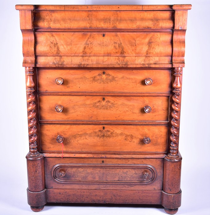 A Victorian Scottish flame mahogany chest with two slide over four graduated drawers, flanked by