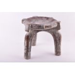 A 19th century African tribal stool 23 cm high, together with four further tribal items. (5)