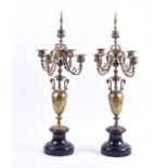 A pair of late 19th century French ormolu candelabra in the Barbedienne style with scrolled arms