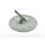 A 20th century or earlier verdigris sundial of circular shape, with engraved Roman numerals and