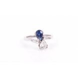 An unusual 18ct white gold, diamond, and sapphire ring in the Toi et Moi style, set with a pear-