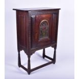 An early 20th century American folk art cabinet the single cupboard door with relief carved and