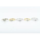 Five various diamond solitaire rings two in yellow gold and three in white gold, the largest diamond
