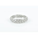 A white gold and diamond eternity ring pave-set with round-cut diamonds, shank unmarked (tests as