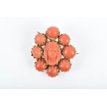 A 19th century coral cameo brooch the central coral cameo within a border of coral beads each