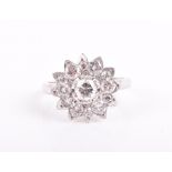 A diamond floral cluster ring centred with a round brilliant-cut diamond of approximately 0.40