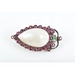 A yellow metal and silver, mother-of-pearl, ruby and emerald brooch of inverted pear-shaped form,