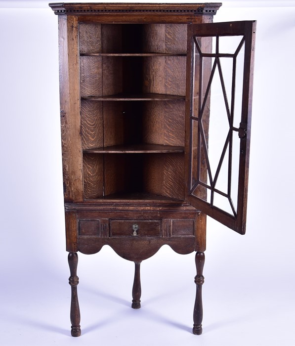 A Georgian oak corner display cabinet with moulded dentil pediment above a glazed door with - Image 4 of 5