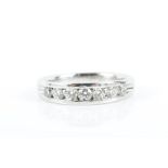 An 18ct white gold and diamond half eternity ring channel-set with round brilliant-cut diamonds of