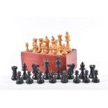 An early 20th century Staunton pattern chess set with carved boxwood and ebony pieces, within a