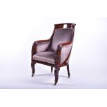 A Regency Grecian style mahogany upholstered armchair in the manner of Gillows, the shaped frame