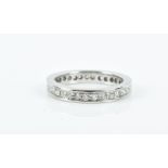 A white metal (tests platinum) and diamond eternity ring ring size I, 4.9 grams, 3.1 mm wide.