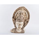 An Indian relief-carved marble bust of Guanyin (or other female Buddhist deity) in serene pose