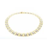 An 18ct yellow gold and diamond collar necklace with articulated white and yellow gold segments, set