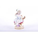 A late 19th century Meissen porcelain figure modelled as a seated lady holding a mirror up to her
