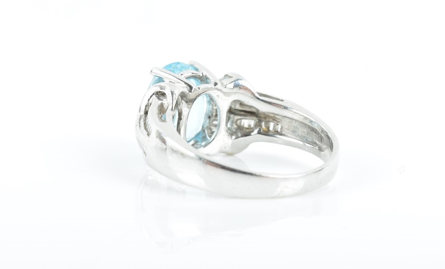 An 18ct white gold, diamond, and blue topaz ring set with an oval-cut topaz of approximately 4.0 - Image 2 of 3