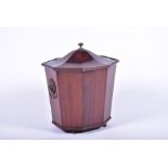 A Regency mahogany veneered cellarette designed with faceted octagonal edges and a domed top, with