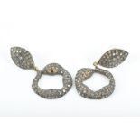 A pair of silver gilt and diamond earrings in the form of stylised snakes with orange garnet eyes,