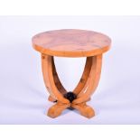 An Art Deco style walnut veneered occasional table of circular form on four curved legs with