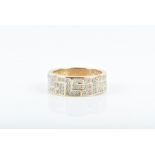 A 9ct yellow gold and diamond gents ring the wide band inset with round-cut diamonds, size U 1/2,