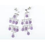A pair of diamond and amethyst drop earrings the white metal mounts (unmarked, test as gold)