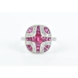 A diamond and ruby ring in the Art Deco style, the squared mount centred with a mixed oval-cut